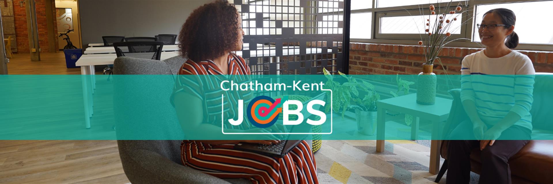 Image of two diverse women having talking and talking about employment